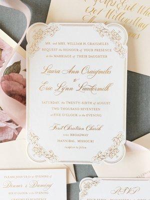 Gold foil press invitation with die cut and watercolor floral envelope liners.