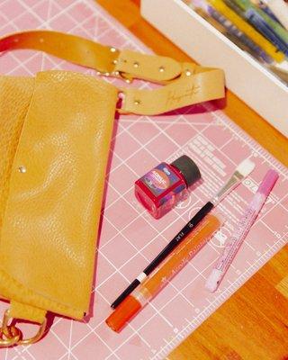 Customize your bag! Leather stamping and painting at our DIY bar.