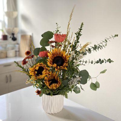 Bright sun flower arrangement with roses and eucalyptus