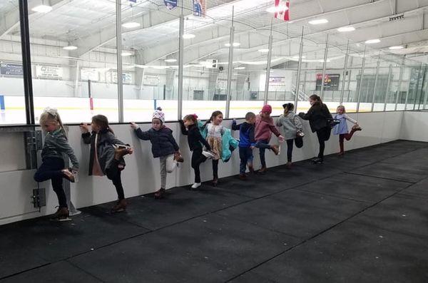 Picture of a group of young friends at the hockey rink at Huntsville Ice Sports Center.