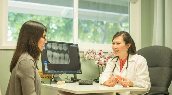 Dr. Tina Le discussing dental care plan with a patient.