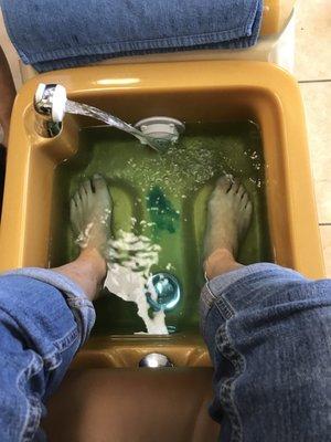 Feet are being soaked in hot water