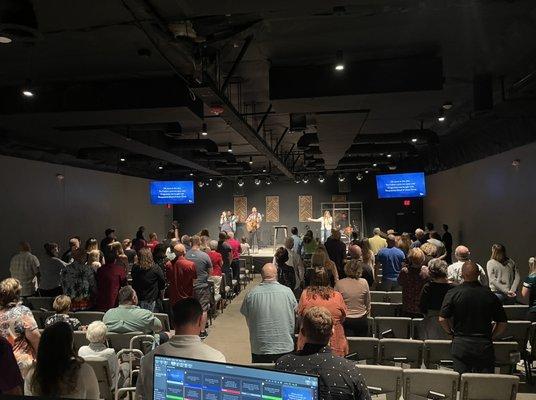 Sanctuary full of people worshipping Jesus