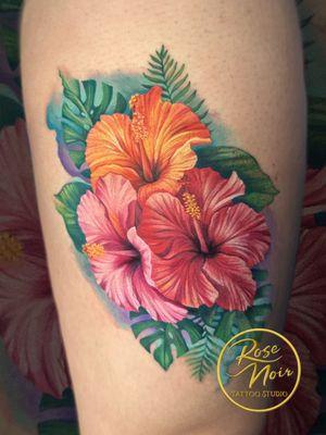 Vibrant hibiscus flower tattoo by shop owner and tattoo artist Megan Wood.