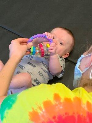 Baby joyfully playing with a toy