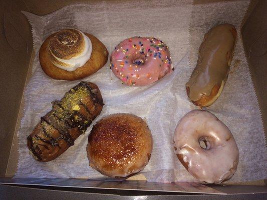 1/2 dozen donuts: Lemon meringue, strawberry glazed with sprinkles, maple long John, cannoli, pumpkin brûlée, plain glazed.