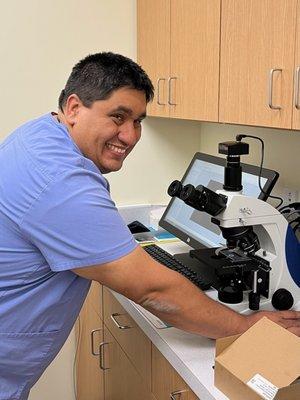 Dr. Notario diagnosing a patient with the help of his microscope.