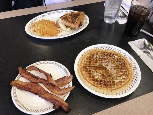 Bacon egg and cheese melt and a waffle with side of bacon.