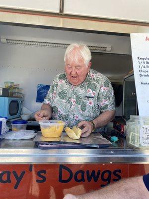 Mr. Jay fixing the cheese on one of our DAWGs.