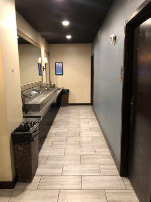 Bathrooms with a shared washing area. A great way for people to meet... or to find out who's really nasty and doesn't wash their hands...