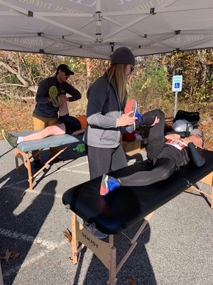 PTs Jackie and Zach help runners with post race recovery at the South Shore Half Marathon.