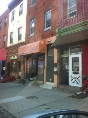 Front of store big orange awning