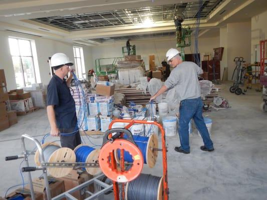 Technicians wiring for install at job site