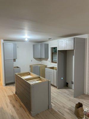 Kitchen cabinet installation with custom island.