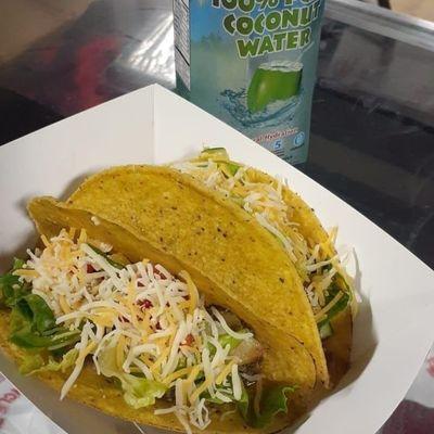 Jerk tacos, in a taco shell with lettuce and tomatoes,  toss with jerk sauce.