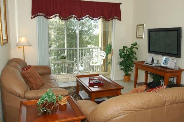 Our living room with sleeper sofa, TV and lanai (balcony)