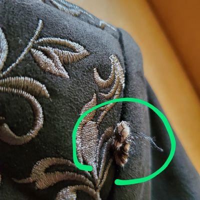 Flap of material sticking out of seam at shoulder of jacket!!