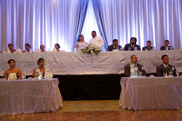 Sequin table covers, pipe and draping, and uplighting provided by REA Designs