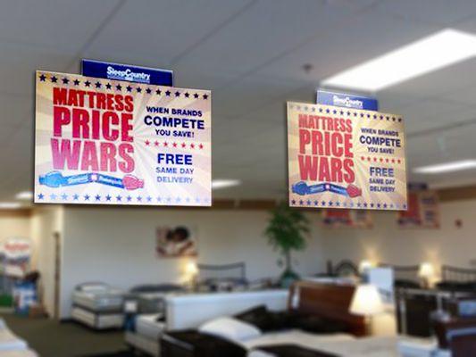 Hanging signs for Sleep Country USA.