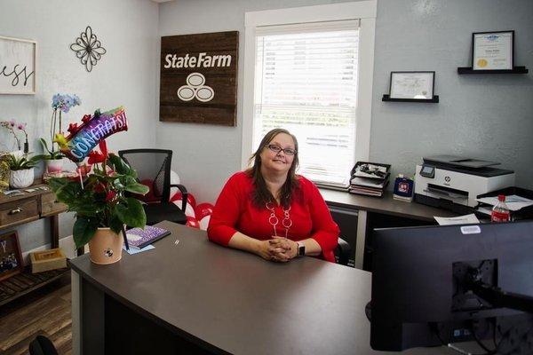 Traci in her office, ready to help.