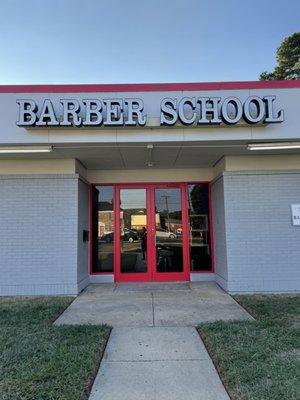 The No Grease Barber School store front.