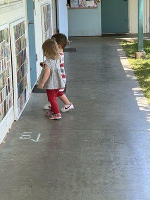 Nursery Babes holding hands and admiring our Iconic Tile Walls