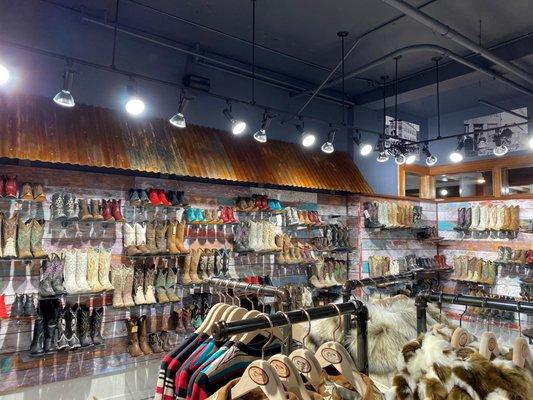 Our very bright and fun boot wall, come find some boots for a night on the town or a weekend at the ranch!