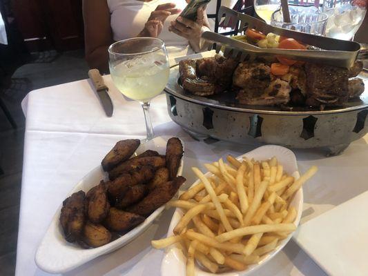 Meat assortment dish , maduros and french fries