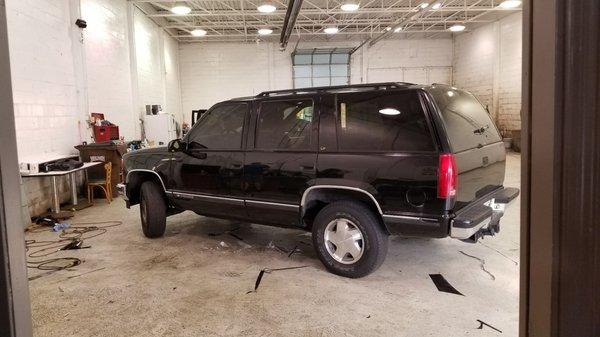 My Tahoe in their workshop after them matching the front tint to the back.