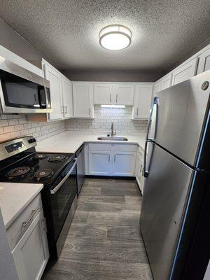 newly renovated kitchen that's all electric with stainless steel appliances