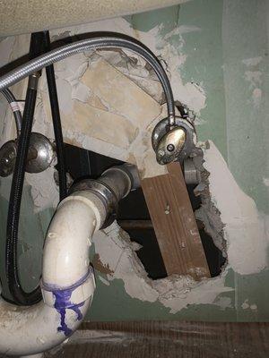 Gaping hole under kitchen sink.