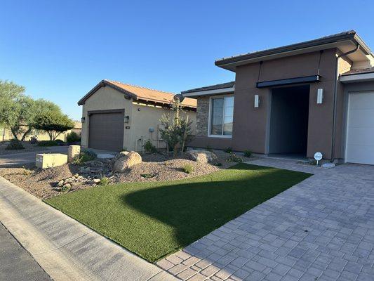 Front yard from right with boulders to hide propane tank.