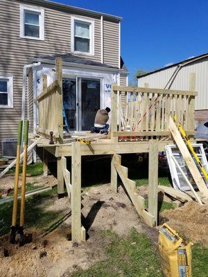 Making a Deck in the backyard and replacing a small window with a sliding door.