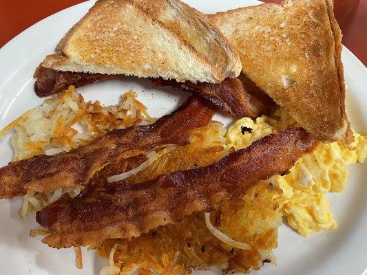 Delicious scrambled eggs, hash browns, bacon & toast