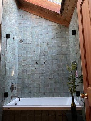 Floor to sloped ceiling tile with a perfectly executed, custom framed niche on the backside. Shower doors by Glasco out of Seaside.