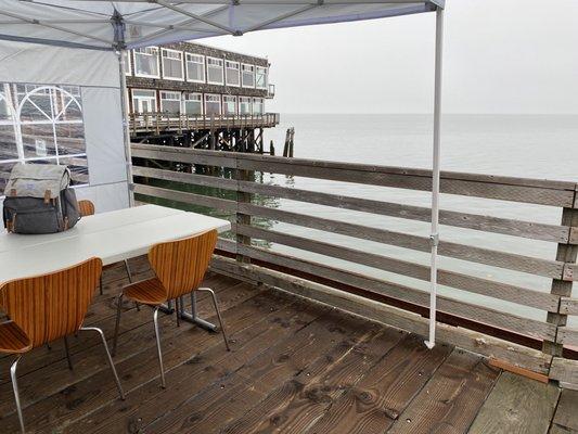 Outdoor covered seating on large deck.