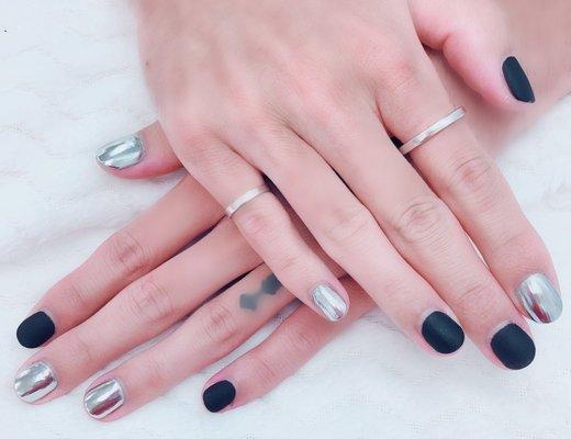 Gel manicure with silver chrome and matte black polish.