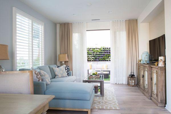 Living room with custom drapes and view of live plant wall.