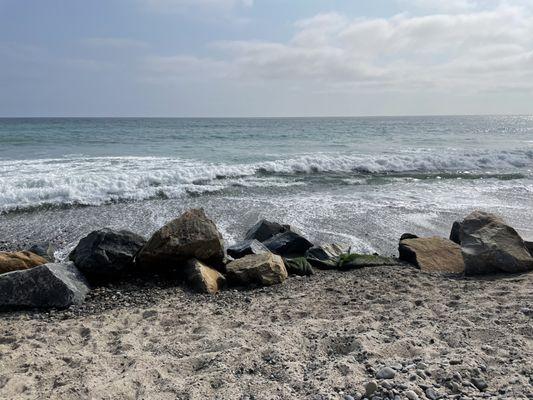 Boulders at bottom of sand hill off deck