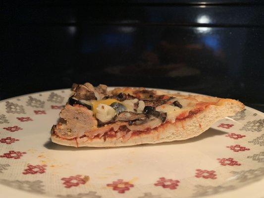 Re-heating the next day in the microwave; you can see how thin the crust is, just a few inches from the outer edge.