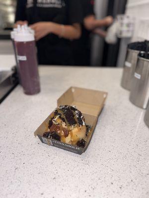 Brookie Cinnamon Roll. Chocolate icing, cookie dough, brownie pieces, "Oreo" cookies and caramel drizzle