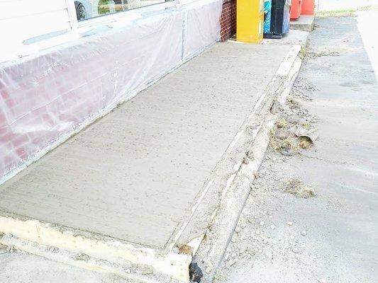 Hand poured cement sidewalk.