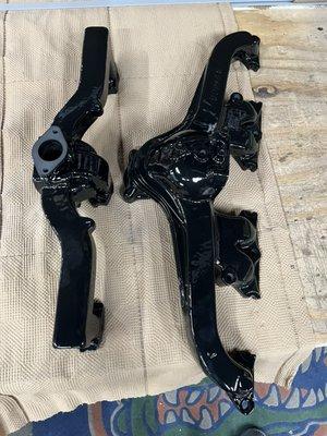 Antique car manifolds refinished in gloss black porcelain enamel. This was a service provided by the manufacturer back in the day.