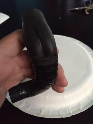 The sliced hose wrapped in electrical tape.