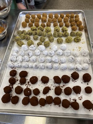 Truffles dusted in cocoa, pistachio, graham cracker and powdered sugar