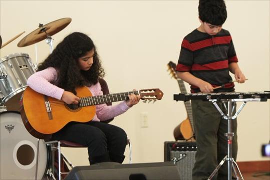 Sister and brother duo perform at a recital.