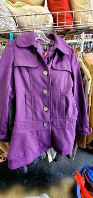 Purple peacoat with silver buttons down the front. I think this is super cute! It is a size S (small) in women's.