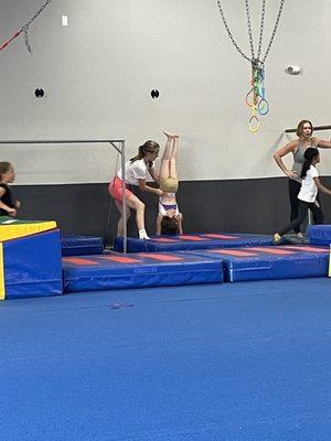 My daughter is in the back doing handstand on the wall.