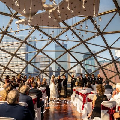 Wedding ceremony inside the Millennium Hotel, Minneapolis, Minnesota.Gorgeous view of the downtown skyline as a backdrop.