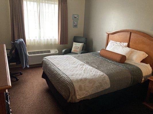 Bed near window in a two-queen-beds room.